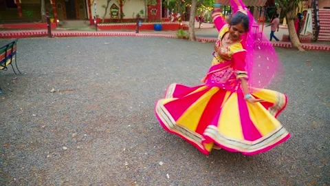 Folk dancer in bright attire performs veiled dance Stock Footage 307281662