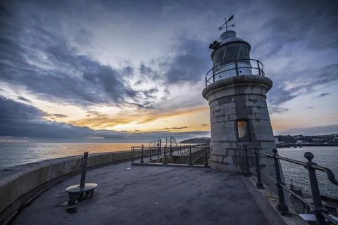 The Folkestone lighthouse at dusk. Stock Photos