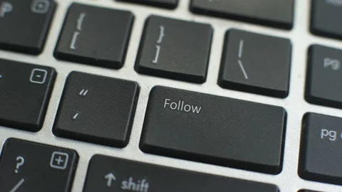Follow button on computer keyboard, female hand fingers press key Stock Footage 97825693