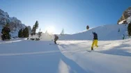 Follow Close Up: Happy Skier And Snowboarder Having Fun Skiing, Snoboarding Back Stock Footage