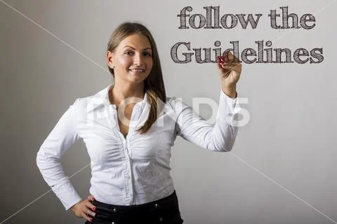 Follow the Guidelines - Beautiful girl writing on transparent surface Stock Photos