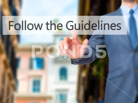 Follow the Guidelines - Businessman hand pressing button on touc Stock Photos