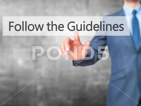 Follow the Guidelines - Businessman hand pressing button on touc Stock Photos