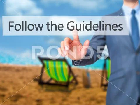 Follow the Guidelines - Businessman hand pressing button on touc Stock Photos