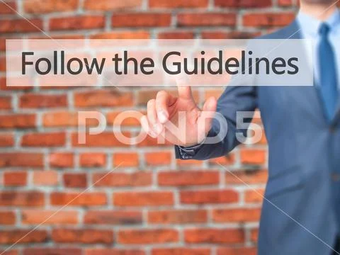 Follow the Guidelines - Businessman hand pressing button on touc Stock Photos
