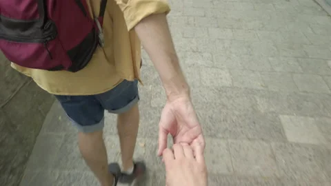Follow me concept man backpacker holding hand of girlfriend leading way to old c Video stock 146278822