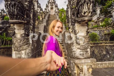 Follow me photo. Young woman tourist on background of Three stone ladders in Stock Photos