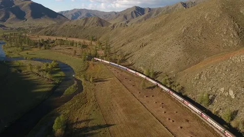 Follow passengers train between North Mongolia high mountains RZD Aerial 4k  Video stock 74795413