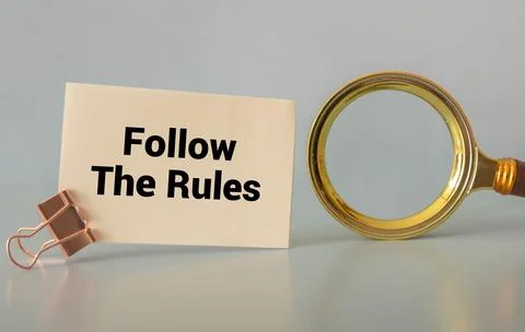 Follow The Rules text written on a notebook with pencils. Stock Photos