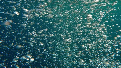 Follow shot of air bubbles from view above to bubbling water surface Stock Footage 333951153