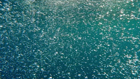 Follow shot of air bubbles from view above to bubbling surface of water Stock Footage 337450254