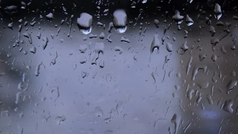 Follow shot of raindrop as it flows down glass window pane 動画素材 118273767