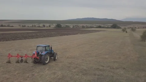 Follow shot of tractor preparing to start cultivating the land Stock Footage 116074571