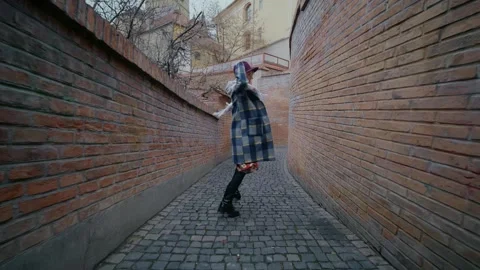 Follow-up shot of womans back walking on empty street. Stock Footage 296549166