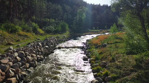 Follow a stream's path as it flows through a valley in Colorado Stock Footage 247364120