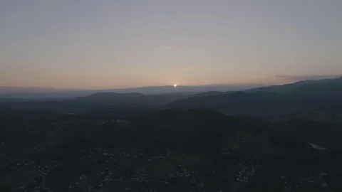 Follow the sun until it disappears entirely into the horizon of a hill, 4K Stock Footage 73127035
