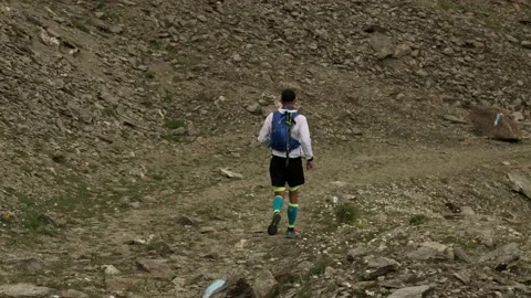 Follow view of sky-runner running high in the mountains. Stock Footage 138577147