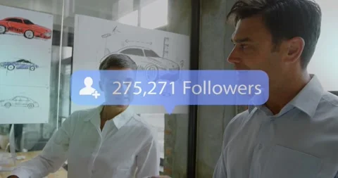 Follower overlays appearing, designers pointing and holding model, showing Stock Footage 331380298