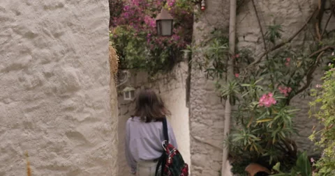 Following Back View Shot of a Beautiful Young Brunete Woman Wearing a Backpack Stock Footage 154334833