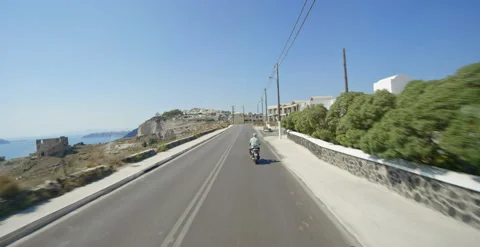 Following behind moped rider in developing area of Santorini, Greece Stock Footage 202260914
