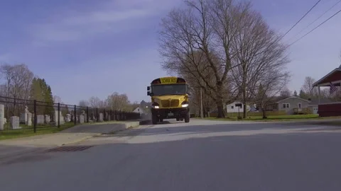 Following a bus as it drives down a suburban street Stock Footage 130753916