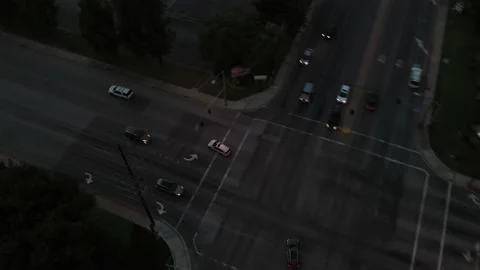 Following Car making left turn at light going down arrow highway into sunset 스톡 동영상 150936397