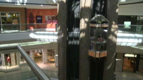 Following elevator as it descends in mall (2 of 2) Stock Footage 32326980