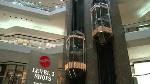 Following elevators descending at Level 3 within mall (2 of 2) Stock Footage 32327049