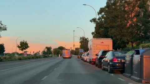 Following an EMT bus at sunset through a Madrid avenue Vidéo 338195053