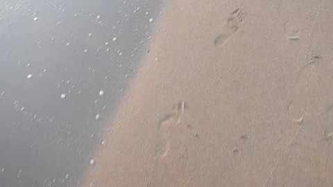 Following footprints on the sand Stock Footage 105200712