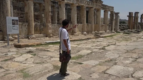Following the guide explaining about Hierapolis city ruins Stock Footage 116368392