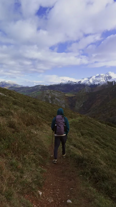 Following hiker with backpack along mountain trail in Spain. Video stock 337653523
