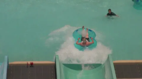 Following Man on Tube Going Down Water Slide Stock Footage 30498915