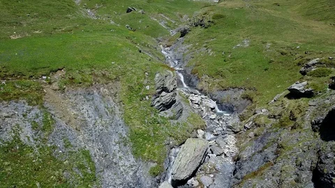 Following a river upstream in the mountains 2 Stock Footage 128716207