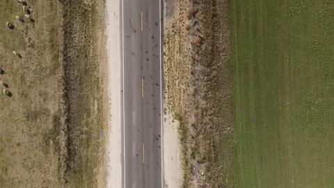 Following a road while panning up using drone Stock Footage 144298656