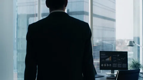 Following Shot of the Confident Businessman in a Suit Walking Through His Office Stock Footage