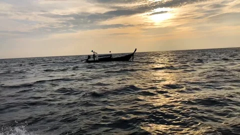 Following small boat on the Ocean while sunrise. Stock Footage 86447020