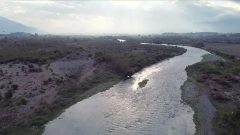 Following a small river. Sun rays at the background. Stock Footage 159395834