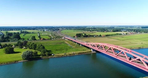 Following A Sprinter Train Crossing the Dutch Hanzeboog Bridge, 4K Drone Stock Footage 117103159