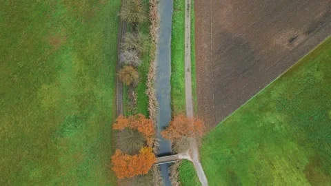Following a stream between fields Stock Footage 228731592