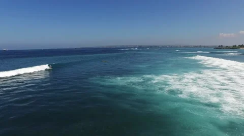 Following a surfer riding a wave Stock Footage 61947655