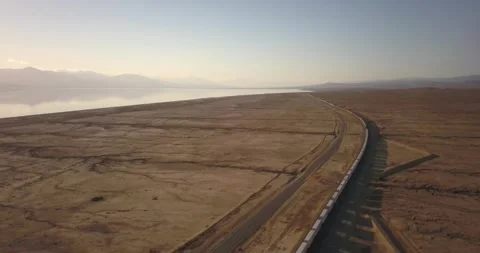 Following a train through the desert next to the salton sea Video stock 276854658