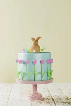 Fondant Easter cake 3D rendering Fondant Easter cake with tulips, a bunny ... Stock Photos