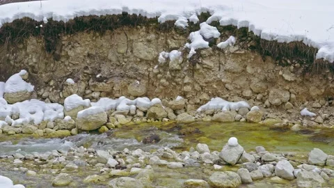 The Fondillo stream flows between the snow and the banks eroded by the water Video stock 146231660