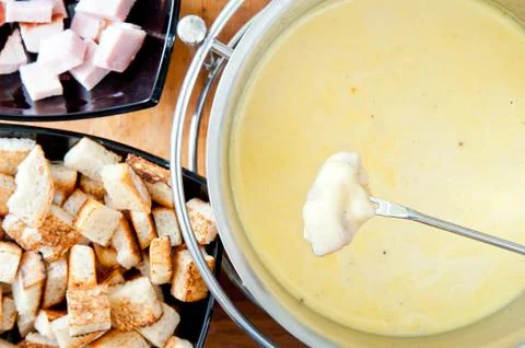 Fondue fork over pot Stock Photos