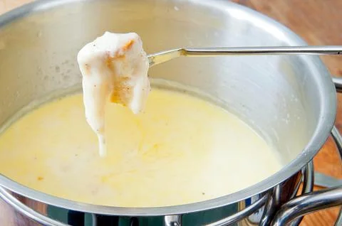 Fondue fork over pot Stock Photos