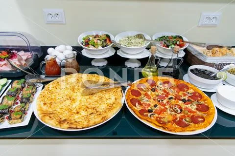 Food and Buffet Decoration with pizza and lots of dishes in a hotel Stock Photos