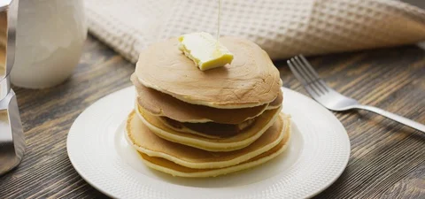 Food and Cooking Concept. Stack of pancakes with butter and warm maple syrup in Stock Footage 127278716