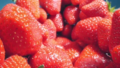 Food background. extremely close up detailed bunch of strawberries on a blue Stock Footage 195014853