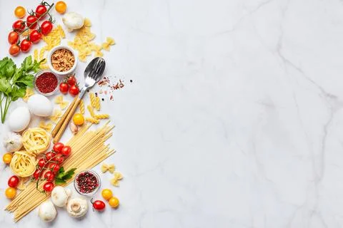 Food background with place for text, with different kinds of pasta, tomatoes Stock Photos
